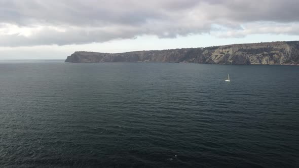 Aerial View From Above on Calm Azure Sea and Volcanic Rocky Shores