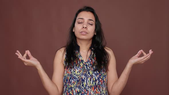 Healthy Woman Meditating in Front of Camera with Yoga Pose