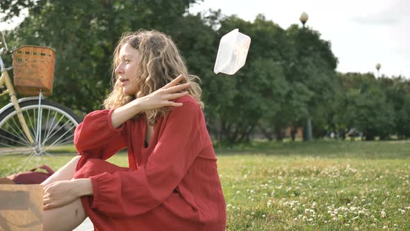 Beautiful Woman in Dress Litter in Public Park, Girl Throws Back on Grass Plastic Container After