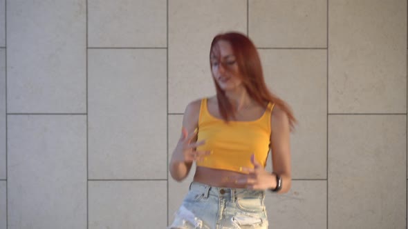 Young Redhead Woman Dancing Hiphop Outdoors