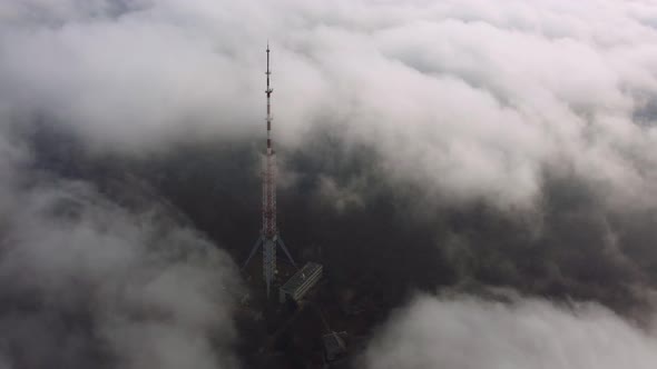 Television Tower Antenna in the Fog at the Summer Day Aerial View