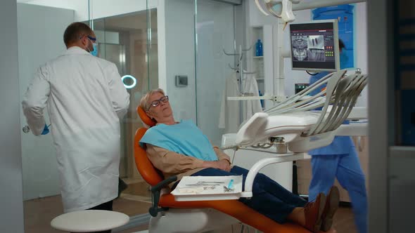 Dentist Examining Teeth with Medical Instruments