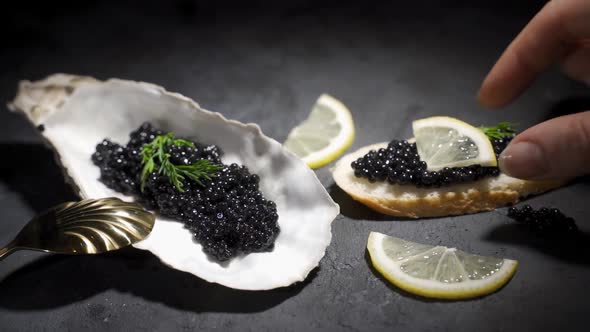 Woman Takes a Sandwich with Black Caviar