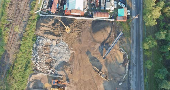 Wheel Frontend Loader Loads Sand Into a Heavy Machinery in the Mobile Jaw Crusher Plant with Belt