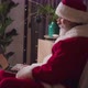 Side Portrait of Santa Claus in His Residence Sitting in an Armchair and Using Laptop Typing on - VideoHive Item for Sale