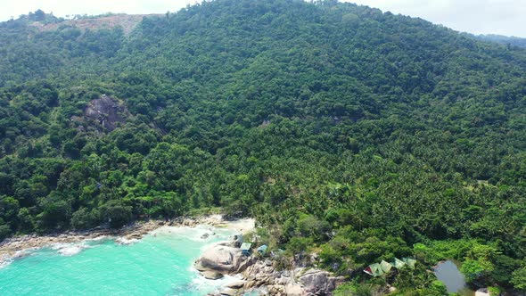 Tropical overhead island view of a white sandy paradise beach and aqua turquoise water background in