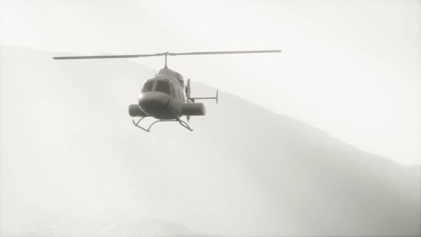 Extreme Slow Motion Flying Helicopter Near Mountains with Fog