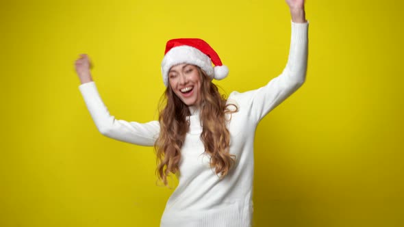 Woman 30s in White Sweater Santa Christmas Hat Dancing Fooling Around Having Fun 