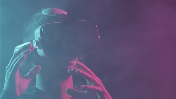 Portrait of a man in virtual reality helmet. Obscured dark face in VR goggles.