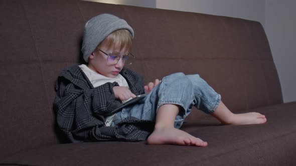 Hipster Little Boy Playing with Tablet at Home