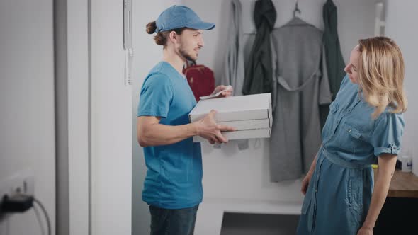 Young Food Delivery Man in a Blue Uniform