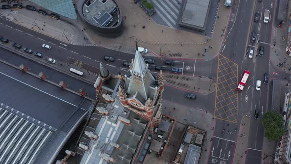High Angle Rotating Footage of Historic Clock Tower Above Road Intersection
