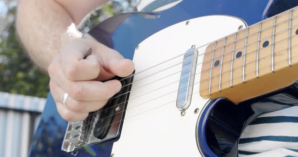 Close Up Male Bassist Hands Playing on Guitar Touching Strings on Rock Performance Man Musician