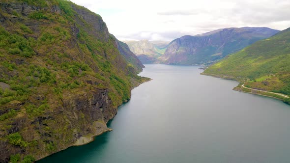 Flying over a stunning Fjord in Norway with lake and Mountains