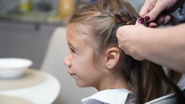 Mother Comb Her Daughters Hair and Braids It at Home