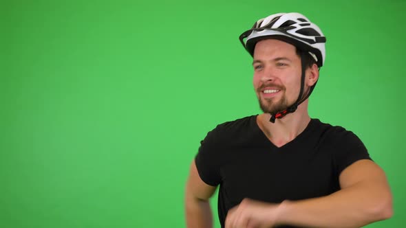 A Young Cyclist Dances and Smiles at the Camera, Finishes with Jazz Hands - Green Screen Studio