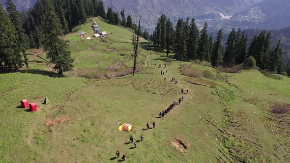 Hikers Walking Down A Hillside Trail In Sar Pass  Aerial Shot