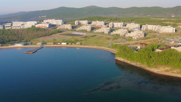 A Modern Complex of Buildings on the Shore of the Bay Surrounded By a Large Park