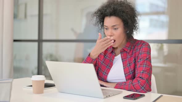 African Woman Reacting to Loss While Using Laptop