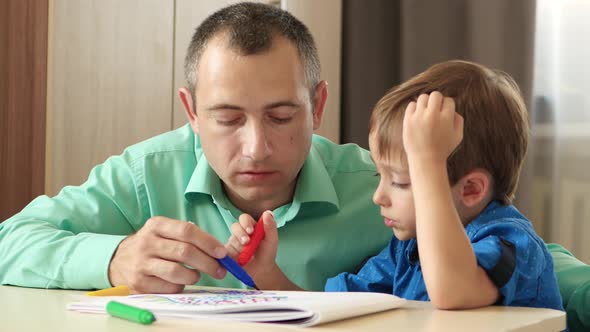 Happy Family. Father and Child. Dad Spends Time with His Son Imagining and Painting a Picture