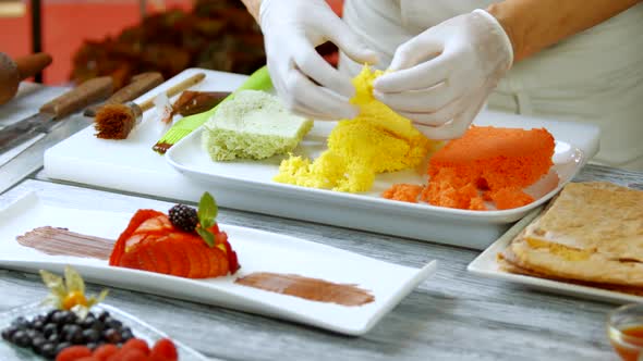 Man's Hands Break Colorful Bread.