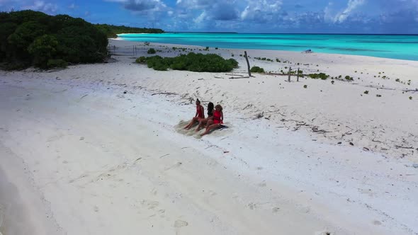 Female models posing on perfect tourist beach journey by blue sea with white sand background of the 