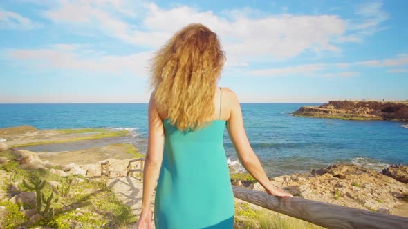 Girl Is Walking Down a Wooden Staircase To the Tropical Coast. Recreation. Summer