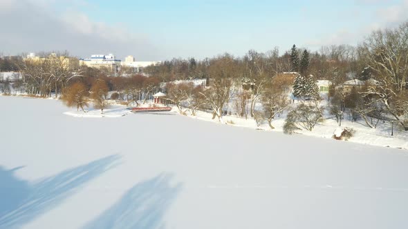 An Island on a Lake with a Bridge in the Winter Loshitsky Park