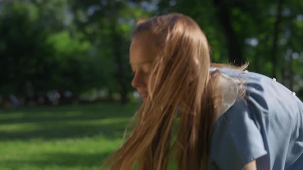 Focused Girl Hit Shuttlecock Toss in Park