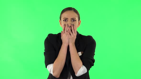 Girl Carefully Examines Something Then Fearfully Covers Her Face with Her Hand, Green Screen