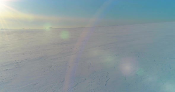 Aerial View of Cold Winter Landscape Arctic Field Trees Covered with Frost Snow Ice River and Sun