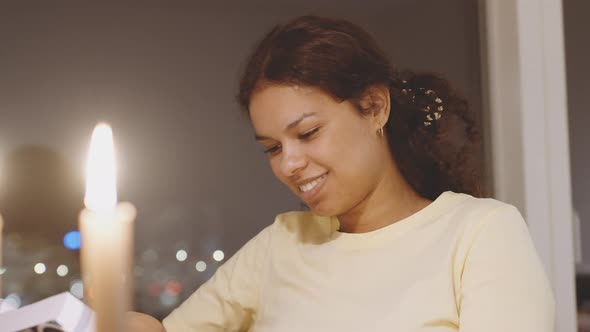 Studying Student Smiling In Candle Light