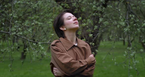 Young Stylish Woman Enjoying Fresh Air Nature Walking in Spring Garden