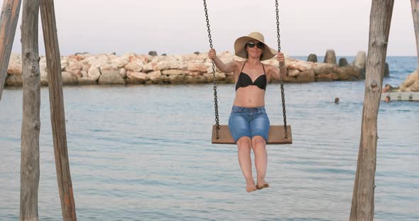 Woman Swings on Beach