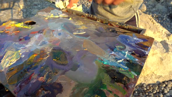 The Artist Mixes Oil Paints on the Palette Using a Palette Knife