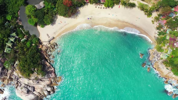 Aerial flying over travel of idyllic resort beach break by aqua blue lagoon and white sandy backgrou