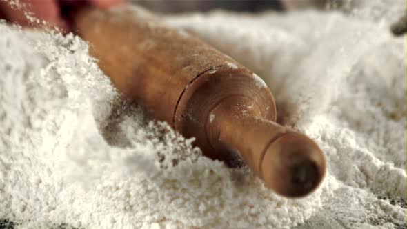 The Super Slow Motion of the Wooden Rolling Pin Falls Into the Flour