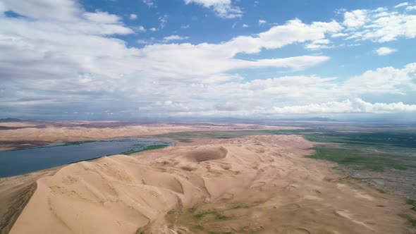 Panoramic view from above on a sandy desert with lakes