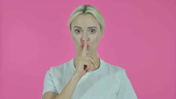 Young Woman Gesturing Silence By Finger on Lips