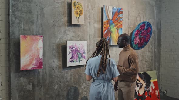 Couple Discussing Artwork on Exhibition