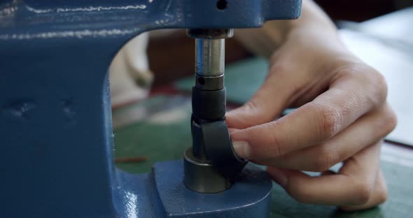 Close Up Shot of Specialist Working with Leather Female Hands Installs Rivets on a Leather Product