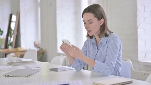 Ambitious Young Woman Celebrating on Smart Phone