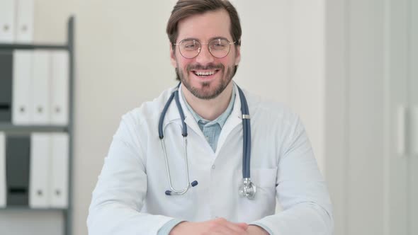 Portrait Thumbs Up Sign By Young Male Doctor
