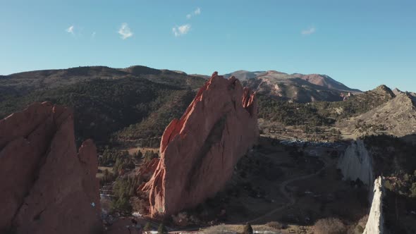 Aerial dolly forward approaching red rock in Garden of the Gods Colorado