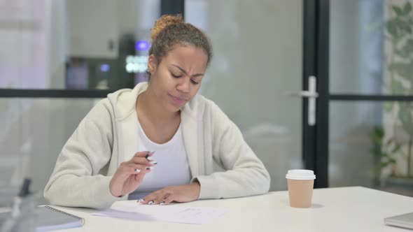 African Woman Having Disappointment While Writing on Pape