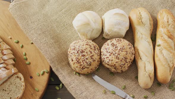 Video of bread on chopping wooden board on wooden worktop