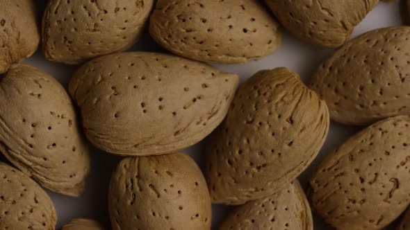 Cinematic, rotating shot of almonds on a white surface - ALMONDS