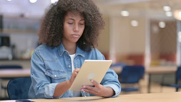 Young African Man Using Tablet at Work 