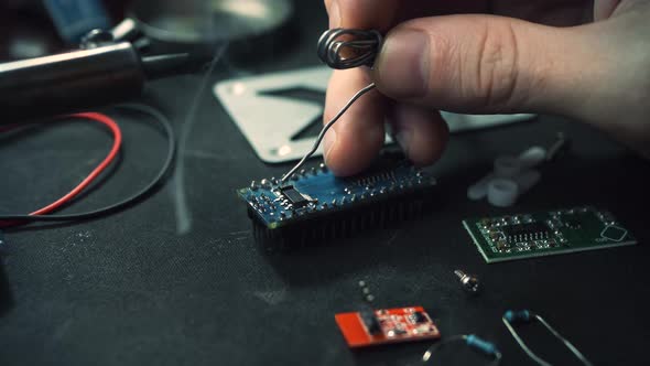 Man Solder the Electronic Printed Circuit Board