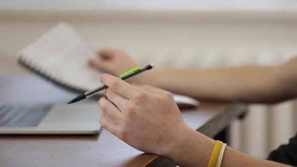 Close up of workplace with laptop and notepad. Work and study at home concept